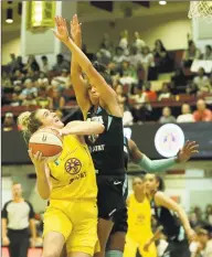  ?? Gregory Payan / Associated Press ?? The Los Angeles Sparks’ Marina Mabrey, left, in action against the New York Liberty in a WNBA game on Saturday.