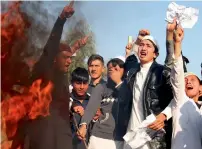  ?? AFP ?? Afghan protesters burn an effigy of US President Donald Trump in Jalalabad on Sunday. —