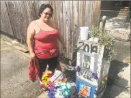  ?? John Nickerson / Hearst Connecticu­t Media ?? Linda Soto, 28, standing next to the memorial to Leobardo Quintero, 43, who died after being pushed to the ground during an argument on lower Alden Street last week.
