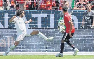  ??  ?? Jesse Lingard (right) of Manchester United scores a goal past Marcelo Da Silva Junior of Real Madrid during the Internatio­nal Champions Cup match at Levi’s Stadium in Santa Clara, California. — AFP photo