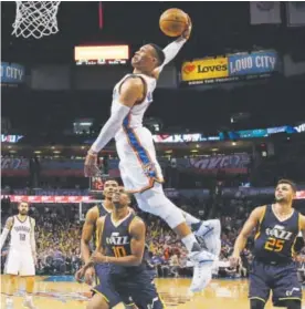  ?? Sue Ogrocki, Associated Press file ?? Oklahoma City Thunder guard Russell Westbrook goes up for one of his many dunks this past season in front of Utah Jazz guards Alec Burks (10) and Raul Neto (25). Westbrook had more triple-doubles than any other player in history in 2016-17.