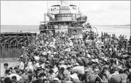  ?? ASSOCIATED PRESS 1975 ?? Refugees crowd a naval vessel docked at a coastal town near Saigon on April 9, 1975. U.S. parole was created under a 1952 law, allowing the president to admit people “on a case-by-case basis for urgent humanitari­an reasons.”