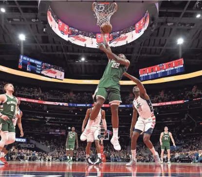  ?? ASSOCIATED PRESS ?? Khris Middleton goes in for a basket past Washington center Ian Mahinmi during the first half.