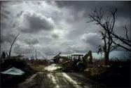  ??  ?? Mos Antenor, 42, drives a bulldozer while clearing the road after Hurricane Dorian Mclean’s Town, Grand Bahama, Bahamas, Friday.