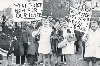  ??  ?? Miners’ wives march from Tower Hill to the Houses of Parliament to demonstrat­e
