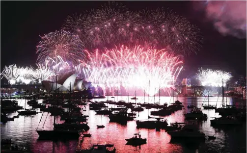  ?? AFP ?? SYDNEY: Fireworks erupt over Sydney’s iconic Harbour Bridge and Opera House during the New Year celebratio­ns today morning.—