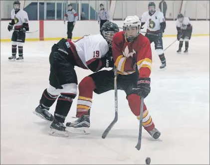  ?? RHONDA HAYWARD/THE TELEGRAM ?? The Inverness Rebels’ Liam Freer (19) checks the Laval Cavaliers’ Justin Edison during the teams’ Confederat­ion Cup high school hockey tournament game Friday at Twin Rinks in St. John’s. The teams finished the game tied 4-4. Play in the 18th annual...