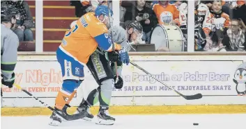  ??  ?? Captain James Ferrara is wrestled off the puck by Hull’s player-coach Jason Hewitt