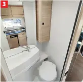  ?? ?? 3 3 Well-appointed washroom has an oblong handbasin and a large lit mirror behind