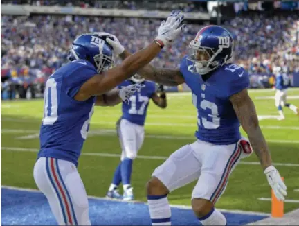  ?? BILL KOSTROUN — ASSOCIATED PRESS ?? Giants wide receiver Odell Beckham, right, celebrates with wide receiver Victor Cruz after scoring touchdown during Sunday’s 28-23 victory over Eagles.