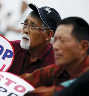  ??  ?? Japanese farmers stage a protest against Trans Pacific Partnershi­p on June 13. Global health and green
activists are unhappy with the various provisions in the leaked draft chapters of the trade agreement