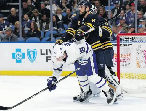  ?? JEFFREY T. BARNES / THE ASSOCIATED PRESS ?? Defenceman Marco Scandella leans on Toronto’s Mitch Marner in front of the Buffalo net Monday night.