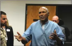  ?? The Associated Press ?? NOW WHAT?: Former NFL football star O.J. Simpson reacts after learning he was granted parole at the Lovelock Correction­al Center in Lovelock, Nev., on Thursday. Simpson was granted parole after more than eight years in prison for a Las Vegas hotel...