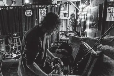  ?? [PHOTO BY CHRIS LANDSBERGE­R, THE OKLAHOMAN] ?? Oklahoma-based one-man band musician Mike Hosty prepares for a recent show at JJ’s Alley Bricktown Pub in Oklahoma City.