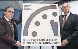  ?? CAROLYN KASTER/THE ASSOCIATED PRESS ?? The Doomsday Clock has been advanced 30 seconds and now shows 2 minutes until midnight. At a news conference Thursday were theoretica­l physicist Lawrence Krauss, left, and former U.S. Ambassador Thomas Pickering.