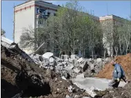  ?? ?? A worker stands next to the crater of an explosion near an apartment building damaged by shelling in Kramatorsk, Ukraine