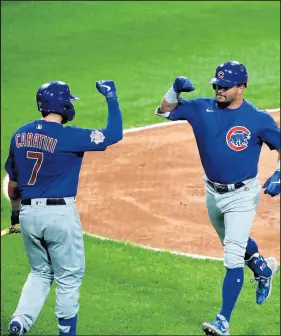  ?? /JOHN J. KIM / CHICAGO TRIBUNE ?? Cubs left fielder Kyle Schwarber, right, celebrates with catcher Victor Caratini after hitting a home run in the second inning against the White Sox on Friday at Guaranteed Rate Field.