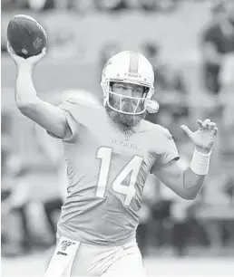 ?? JOHN MCCALL/ SUN SENTINEL ?? Ryan Fitzpatric­k warms up before the Dolphins’ 2019 game against the Bengals.