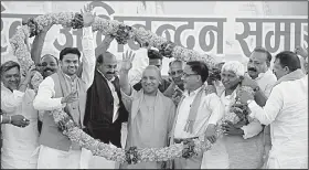  ?? Tribune News Service/Hindustan Times/DEEPAK GUPTA ?? Supporters cheer Yogi Adiyanath (center), the new chief minister of India’s Uttar Pradesh state, on his first visit to his hometown of Gorakhpur after a swearing-in ceremony March 25. His followers believe he will realize their dream of a temple to the...