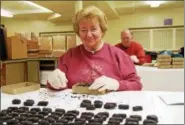  ?? SUBMITTED PHOTO — ST. MARK’S CHURCH ?? Volunteers at St. Mark’s Church in Conshohock­en create the church’s signature Easter egg candies. The church has been making the holiday treats for 100 years.