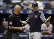  ?? CHRIS O’MEARA — THE ASSOCIATED PRESS ?? New York Yankees manager Aaron Boone, right, argues with home plate umpire Vic Carapazza after starting pitcher CC Sabathia was ejected for hitting Tampa Bay Rays’ Jesus Sucre with a pitch during the sixth inning of a baseball game Thursday, Sept. 27, 2018, in St. Petersburg, Fla.