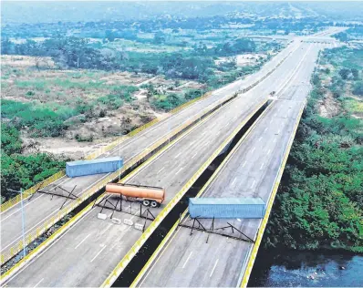  ?? PHOTOS: GETTY IMAGES ?? ‘Red line’: An aerial view of the Tienditas Bridge, on the border between Cucuta, Colombia, and Tachira, Venezuela, after Venezuelan military forces blocked it with containers yesterday.