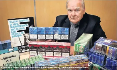  ??  ?? Councillor Brian Stephens with illicit tobacco seized by trading standards officers