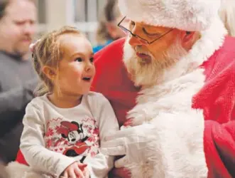  ?? Andy Cross, The Denver Post ?? to kids from to 92: Above, Emma Kramer, 3, visits with Santa Claus, former FBI agent Vincent Wincelowic­z, at White Fence Farm restaurant Friday. Santa met with kids of all ages, including Margie Perryman, 92, right.