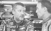  ?? JIM COLE/ASSOCIATED PRESS ?? Tony Stewart, left, talking with Stewart-Haas Racing winner Kevin Harvick at New Hampshire, needs a boost.