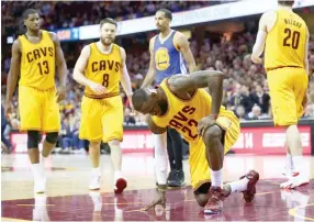  ??  ?? LEBRON JAMES #23 of the Cleveland Cavaliers gets up after falling to the court in the third quarter against the Golden State Warriors during Game Four of the 2015 NBA Finals at Quicken Loans Arena on June 11 in Cleveland, Ohio.