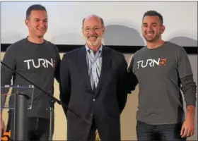  ??  ?? Turn5 co-founders Andrew and Steve Voudouris join Pennsylvan­ia Gov. Tom Wolf,