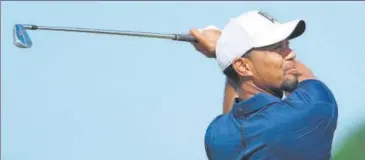  ?? AFP ?? Tiger Woods hits a tee shot on the 12th hole during round two of the Hero World Challenge at Albany.