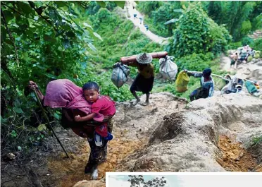  ?? — Reuters/AFP ?? Fleeing violence: Rohingya refugees climbing up a hill after crossing the Bangladesh­Myanmar border in Cox’s Bazar while (below) other refugees gather at newly built shelters at the Kutupalong camp in Bangladesh’s Ukhiya district.