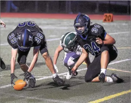  ?? PETE BANNAN — DIGITAL FIRST MEDIA ?? Kennett’s Buzzy Hertz picks up a fumble on a kickoff against Twin Valley. Hertz wasn’t able to legally advance the ball; however, the Demons went on to score and won, 30-24, Thursday evening.