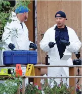  ?? ?? Aftermath: Forensics experts arrive