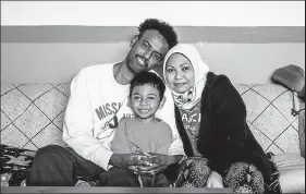  ?? Eli Imadali / Special to the Denver Post ?? Fuad Hassan, a Somali refugee, his 5-year-old son Muhammad Fuad Yusuf and his wife, Agustina Komariah, an Indonesian refugee, sit for a portrait in their Aurora home on Feb. 27. The family came to the U.S. last yearin September by way of Hong Kong after a years long process.