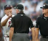  ?? JOHN BAZEMORE - THE ASSOCIATED PRESS ?? Atlanta Braves manager Brian Snitker argues with the umpiring crew after Ronald Acuna Jr was hit by a pitch from Miami Marlins starting pitcher Jose Urena during the first inning Wednesday, in Atlanta. Urena was ejected.