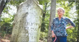  ?? RICHARD PERRY/NEW YORK TIMES SERVICE ?? Joan Tribble at the grave of her great-great-grandfathe­r, Henry W. Shields, a Georgia slave owner who is also an ancestor of Michelle Obama.