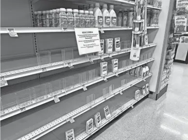  ?? STEPHANIE INNES/THE REPUBLIC ?? Shelves that normally carry infant formula at Safeway in Phoenix, 520 W. Osborn Road, were nearly empty on Thursday.