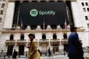  ?? SPENCER PLATT / GETTY IMAGES ?? The Spotify banner hangs from the New York Stock Exchange early Tuesday, the morning the music streaming service began trading shares at the NYSE in New York City.