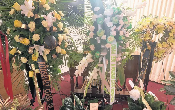  ?? MIKE HUTTON/POST-TRIBUNE ?? Flowers from Roosevelt alumni and Michigan State men’s basketball coach Tom Izzo are among the floral arrangemen­ts at Renaldo Thomas’ wake at the Guy & Allen funeral home in Gary on Thursday.