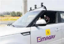  ?? PHOTO: REUTERS ?? Along for the ride . . . A man sits inside a Kia Soul, modified as an autonomous vehicle by the Imagry startup company, ahead of a driving demonstrat­ion near Shfayim, Israel.