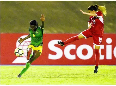  ?? FILE ?? Captain Konya Plummer (left) makes a clearance as Cuba’s Yennifer Ramos Lopez lunges in during Jamaica’s FIFA Women’s World Cup qualifying game at the National Stadium in Kingston on Sunday, September 2, 2018.