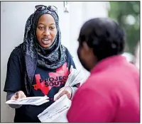  ?? The New York Times/MELISSA GOLDEN ?? Nicole Fauster, an intern with the nonprofit Project South organizati­on, hands out civil-rights informatio­n Saturday in Decatur, Ga., ahead of the immigratio­n raids planned for today.