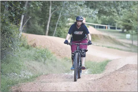  ?? (NWA Democrat-Gazette/Charlie Kaijo) ?? Sonia Perez rides at Slaughter Pen in Bentonvill­e. Perez is a beginning mountain biker who wanted to take advantage of the miles of soft-surface trails in the region. She recently purchased her first bike.