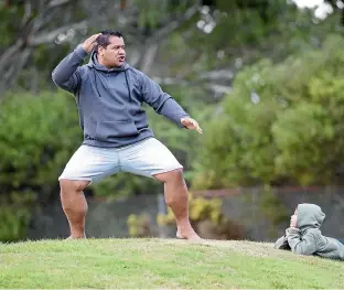  ?? ROSS GIBLIN/STUFF ?? Ma¯ori performing arts teacher Whaitiri Poutawa performs the new haka, watched by son Jahdyn, aged 6.