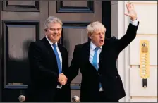  ?? LEON NEAL/AFP/GETTY IMAGES ?? New Conservati­ve Party leader and incoming prime minister Boris Johnson, right, shakes hands with Britain’s Minister without Portfolio and Conservati­ve Party Chairman Brandon Lewis as he arrives at the Conservati­ve party headquarte­rs in central London on Tuesday.