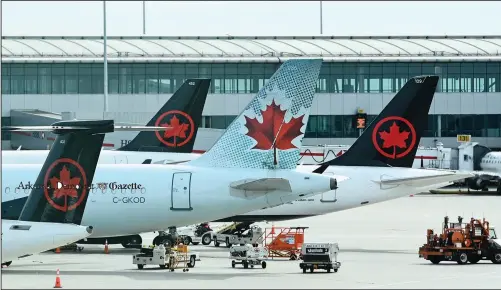  ??  ?? Air Canada planes sit on the tarmac Oct. 14 at Pearson Internatio­nal airport during the covid-19 pandemic in Toronto. Stories circulatin­g online incorrectl­y assert Canada prohibits vaccinated pilots from flying. But Canada’s transporta­tion agency allows pilots to receive any vaccine that’s been approved by the country’s health regulator, Health Canada, according to Transport Canada Senior Communicat­ions Adviser Sau Sau Liu.
(File Photo/AP/The Canadian Press/Nathan Denette)