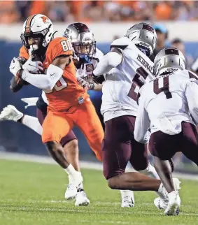  ?? NATE BILLINGS/FOR THE OKLAHOMAN ?? Oklahoma State’s Brennan Presley (80) gets away from a group of Missouri State defenders in the fourth quarter on Sept. 4.