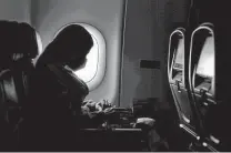  ?? Charlie Riedel / Associated Press file photo ?? A passenger wears a mask during a Feb. 3 flight from Atlanta. The CDC updated its guidance Friday for fully vaccinated travelers.